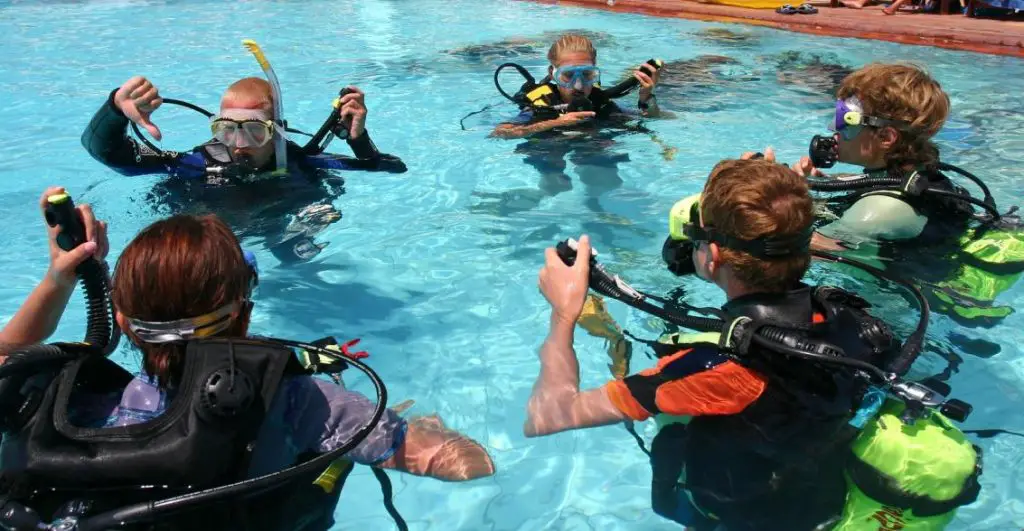 Instructor and students during scuba diving lessons