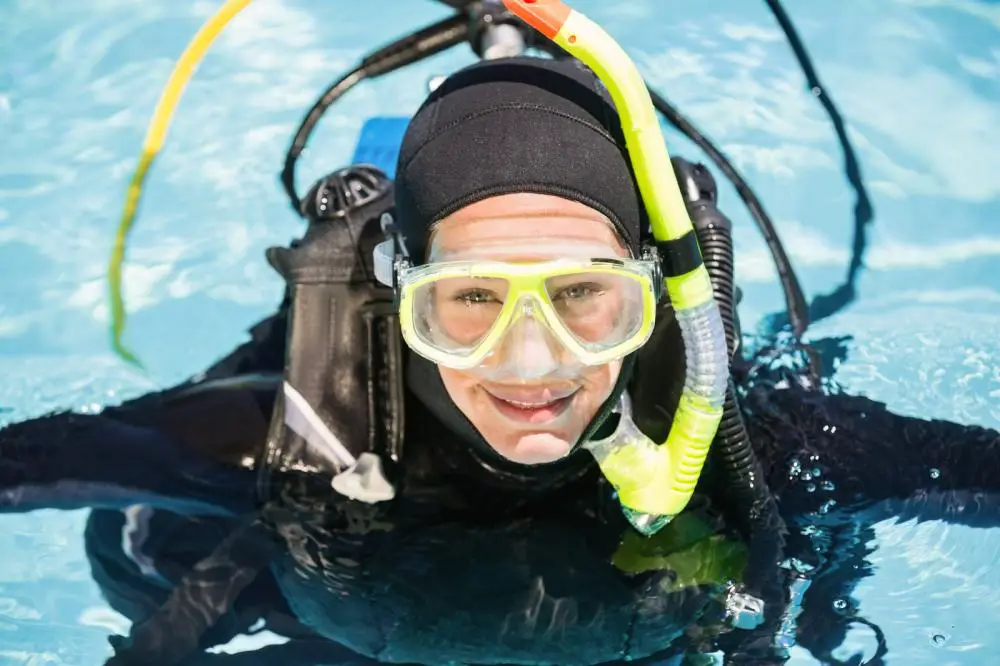 Portrait of young woman on scuba training in swimming pool